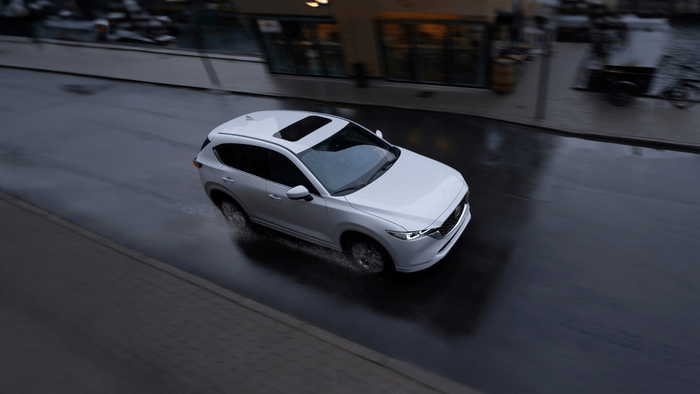 White Mazda CX-5 driving on the street