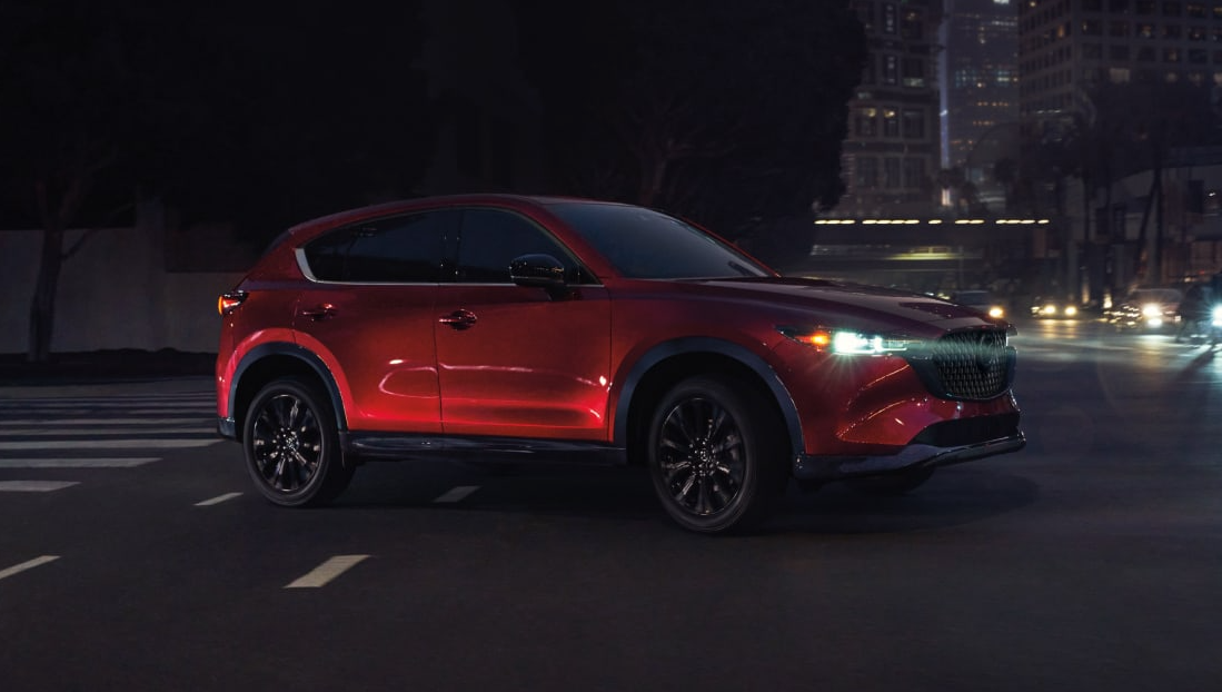 Red 2025 Mazda CX-5 driving on the road
