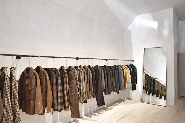 A room with a wall of clothes on the wall