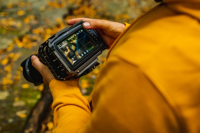 Man reviewing footage on the black magic pocket cinema camera 6K of a woman reviewing an image taken on her camera.