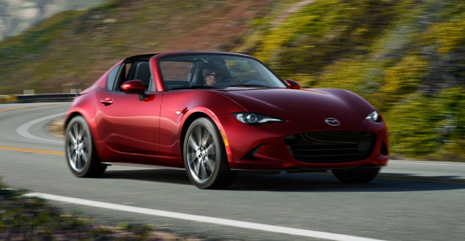 Red 2026 Mazda MX-5 Miata driving on road